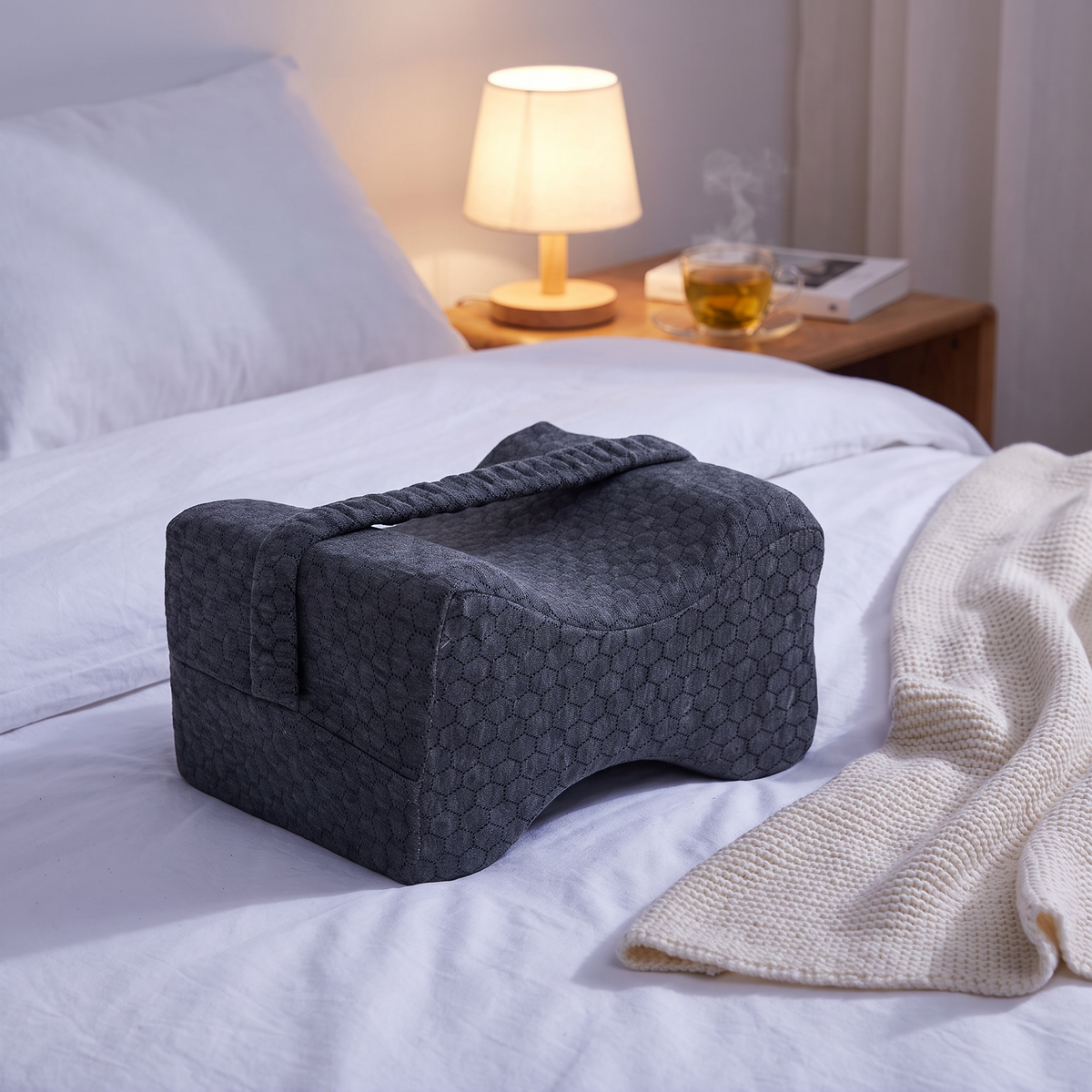 Knee pillow on the bed in the evening